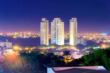 City neighborhood at night with lights on, downtown buildings, Piracicaba SP Brasil.