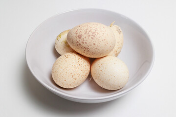 Fototapeta na wymiar Fresh Turkey Eggs on a white background Large speckled eggs (egg shells)