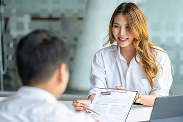 Fototapeta premium Business, career and recruitment concept - young asian woman smiling and holding resume, while interviewing as candidate for job in big company