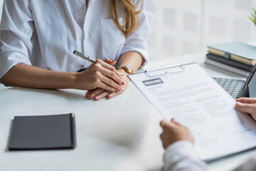 Business, career and recruitment concept - young asian woman smiling and holding resume, while interviewing as candidate for job in big company