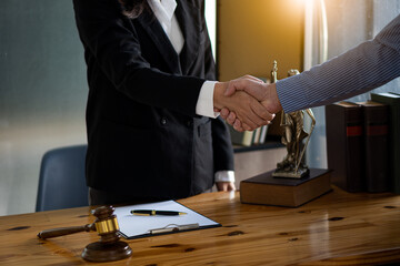 Businessmen and lawyers shake hands to discuss contract documents. Handshake advise after good...