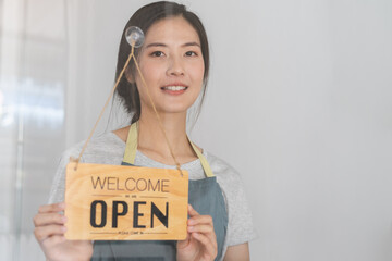 Owner business retail, attractive asian young woman hand in turning sign board to open coffee shop,...