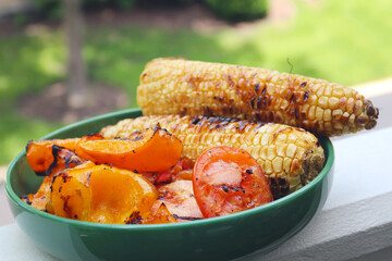 Grilled corn, tomatoes, and pepper BBQ background. Summer barbeque.