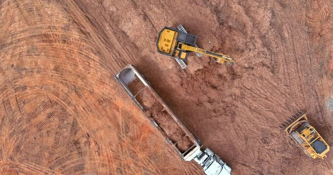 Prepare land for construction site of excavator truck are loading soil a dump truck an aerial view
