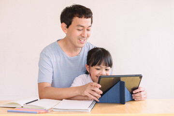 parent and child, Asian father and daughter using digital tablet holding mobile computer watch cartoons educational online program , Father's day,  