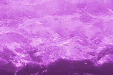 Fototapeta na wymiar Rippled pattern of clean water in a purple swimming pool 