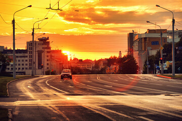 Fototapeta premium Single car on empty road at early morning time