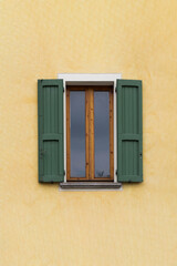 Traditional window of Italian house with closing doors in wood