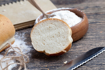 wheat baguette on the table with flour and various plant grains