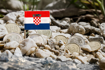 Croatia flag with euro coins amid gravel surface on the riverbank,currency exchange,business finance and economy concept,macro close-up - obrazy, fototapety, plakaty