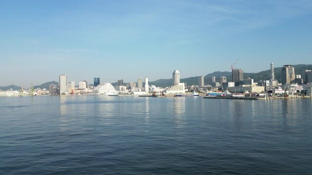 Pullback on Kobe Port revealing small vessel in foreground