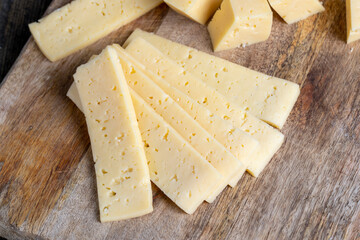 fresh yellow milk cheese on a board