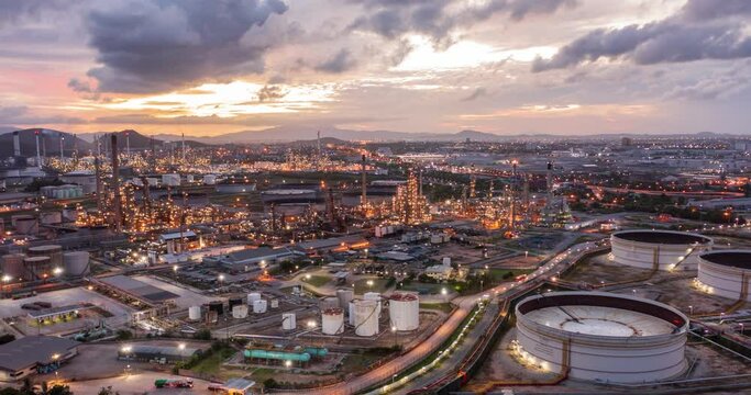 Aerial Hyperlapse Time-lapse of the refinery and oil tank at dusk. Business and petrochemical plants, oil storage tanks, and energy and steel pipes in Twilight time