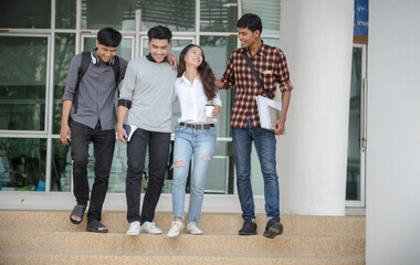 Fototapeta premium Group of Diversity Student talking and laughing together at asian college. Happy multi ethnic friend successfully completes the thesis report and passed final exam in university.