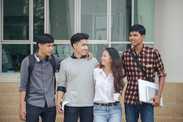 Group of Diversity Student talking and laughing together at asian college. Happy multi ethnic friend successfully completes the thesis report and passed final exam in university.