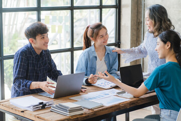 Asian entrepreneur Team of small company drawing a diagram in office during team meeting discussing and analyzing the business situation new startup project in modern loft.