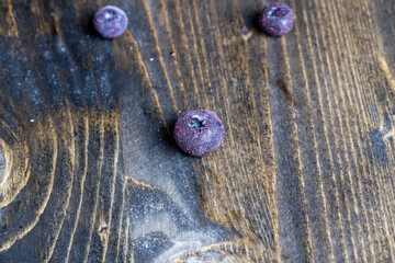 frozen blueberries on a wooden table
