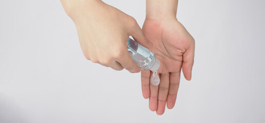 Hands is squeezing alcohol hand gel on white background.TOP eye view.