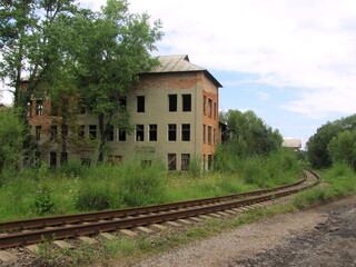 Fototapeta na wymiar Access railway to the abandoned old factory