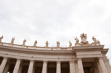 Fototapeta na wymiar Architectural detail of st peters basilica colonnade with statues standing on columns
