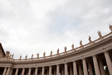 Architectural detail of saint peters basilica colonnade with statues on columns