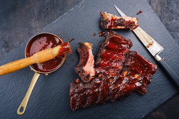 Barbecue pork spare loin ribs St Louis cut with hot honey chili marinade served as top view on a...