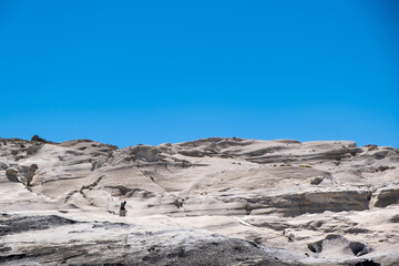Lunar rock background, Sarakiniko Milos island, Cyclades Greece. Natural white stone, blue sky