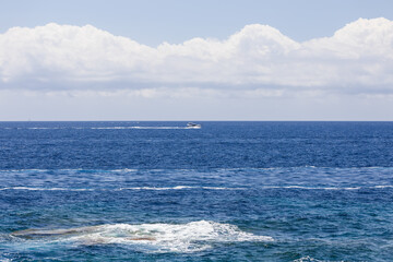 Lone white motor yacht crosses bay leaving  white foam trail behind it, Ibiza, Balearic Islands, Spain