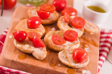 Friselle with cherry tomatoes and olive oil.