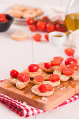 Friselle with cherry tomatoes and olive oil.