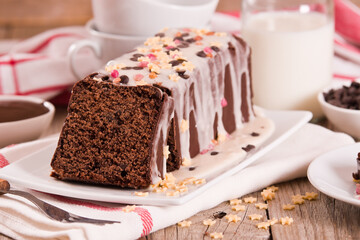 Sponge cake with white frosting and sugars.