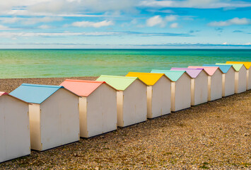 Row of pastel colored bathing huts at Le Treport beach, Normandy, France
