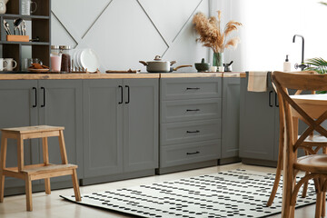 Interior of modern kitchen with grey furniture