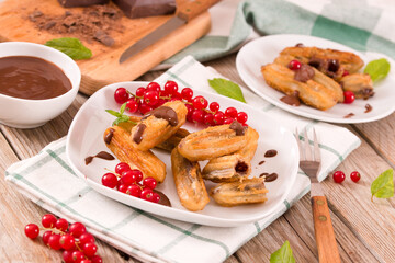 Mini churros with chocolate dipping sauce.