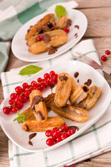 Mini churros with chocolate dipping sauce.
