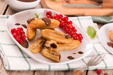 Mini churros with chocolate dipping sauce.