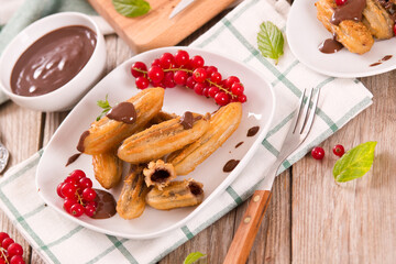Mini churros with chocolate dipping sauce.