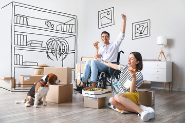 Happy young couple with cute dog eating pizza while planning interior design of their new home
