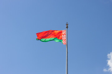 The waving flag of Belarus at the blue sky background