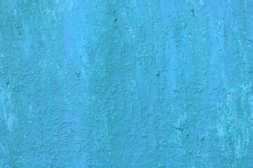 Beautiful vintage blue background with old blue paint with a rough surface, streaks and uneven texture of blue paint on an old rough surface