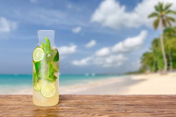 Bottle of fresh mojito on table at sea resort