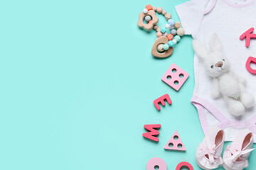 Educational toys with baby bodysuit on blue background