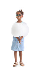 Little African-American girl with cotton candy on white background