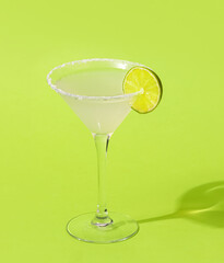 Glass of tasty margarita cocktail on color background