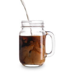 Pouring of milk into mason jar with iced coffee on white background