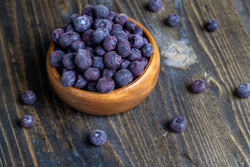 frozen blueberries on a wooden table