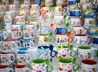 Multicolored owl mugs on the shelter - 508989850