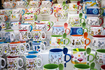 Multicolored owl mugs on the shelter - 508989896