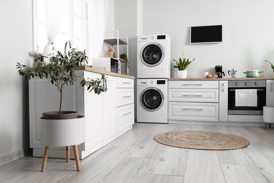 Stylish Interior Of Kitchen With Modern Washing Machines