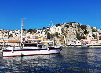 Small boat in the harbor of Symi island, Greece.